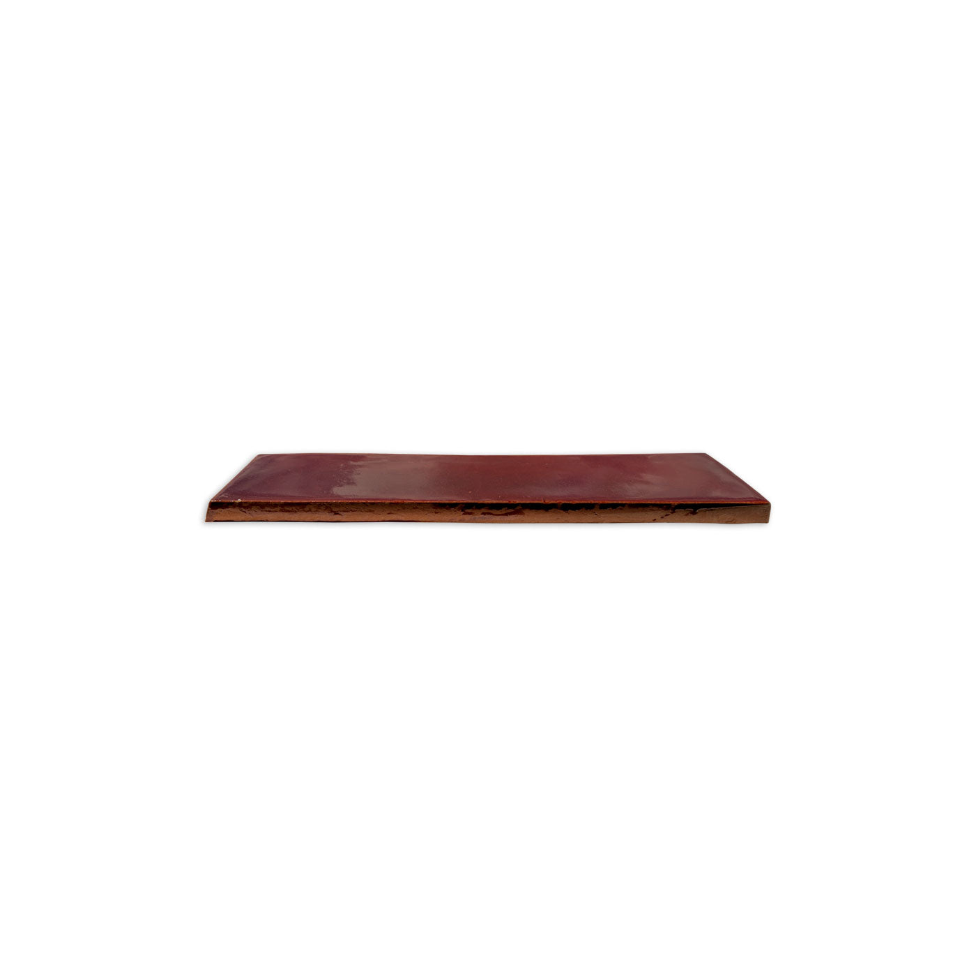 Oxblood Matchstick Solid Tile by Clay Imports, with a smooth glossy top and rough earthen side.