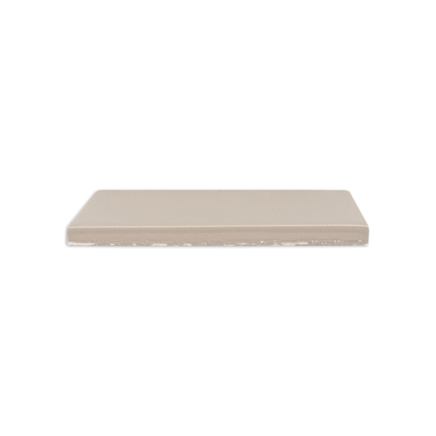 Palo Santo Matte 2x5 Solid Tile by Clay Imports, a beige rectangular tile with a smooth top and unglazed bottom edge, viewed from the side.