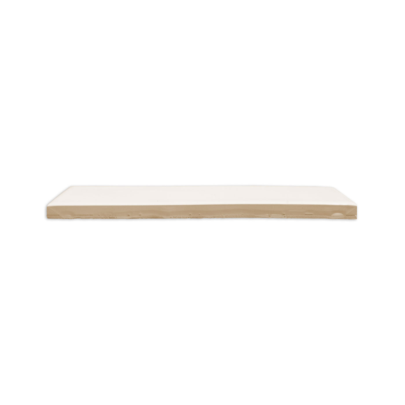 Light beige glossy solid tile by Clay Imports, side view showing its smooth top and rough underside.