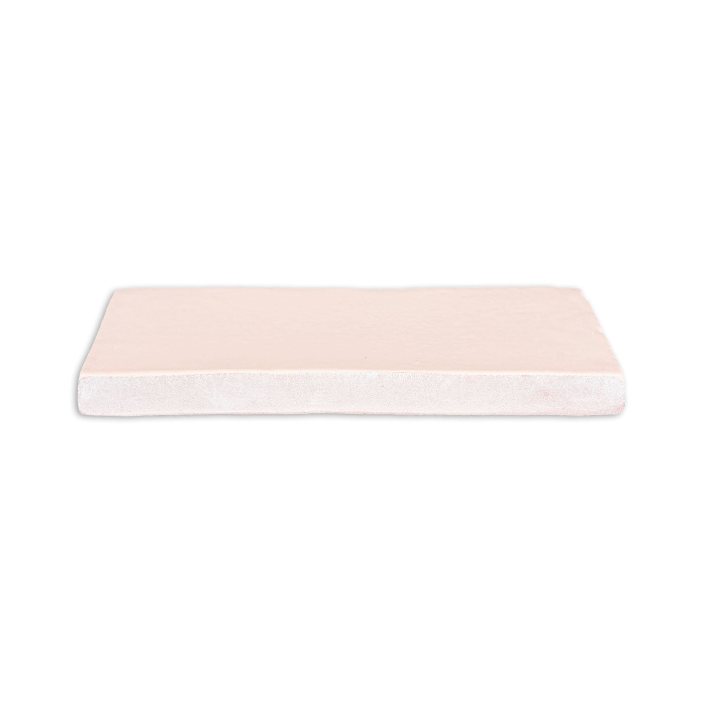Matte pale peach rectangular tile by Clay Imports with a visible unglazed side edge.