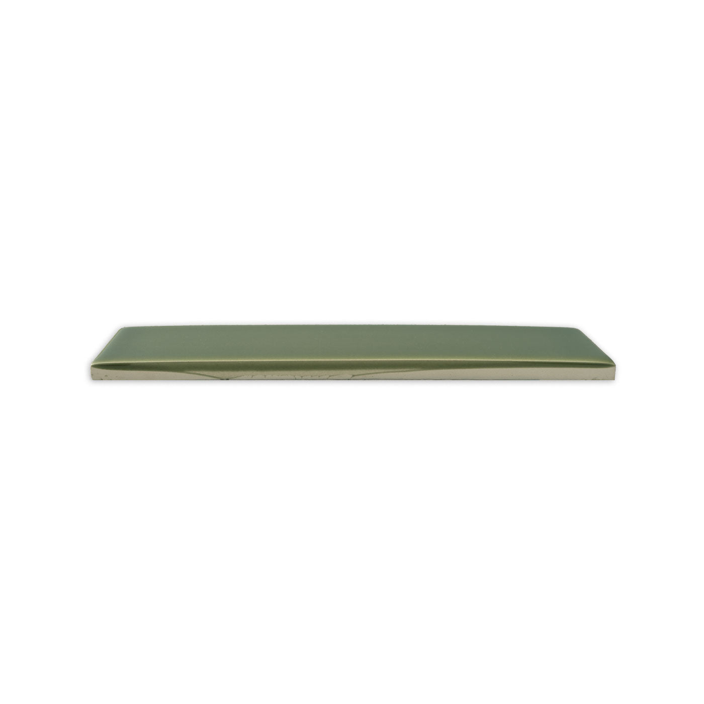 Green gloss solid tile by Clay Imports, shown in a side view with a light underside.