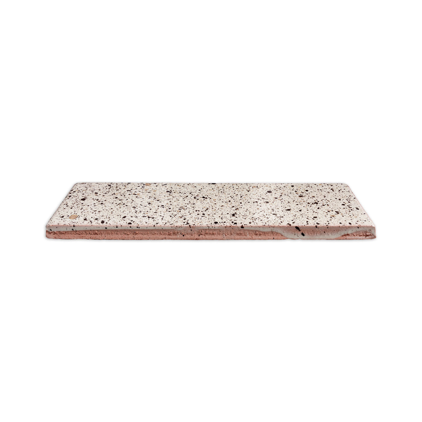 Rectangular white speckled clay tile by Clay Imports with a pinkish clay base, viewed from a low angle.