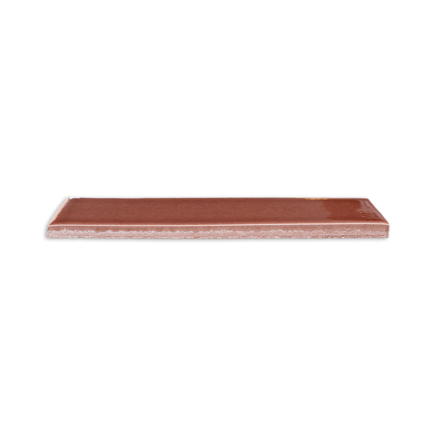 Tamarindo glossy solid tile by Clay Imports, rectangular, with a smooth surface and visible textured side.