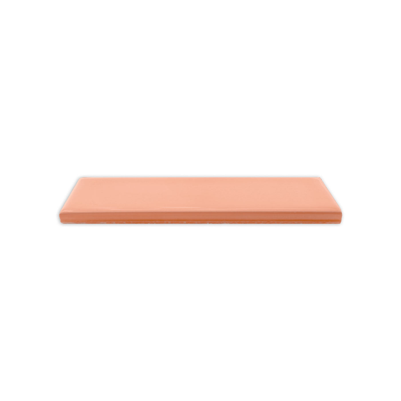 Glossy salmon 2x5 inch solid tile by Clay Imports, viewed from the side against a white background.