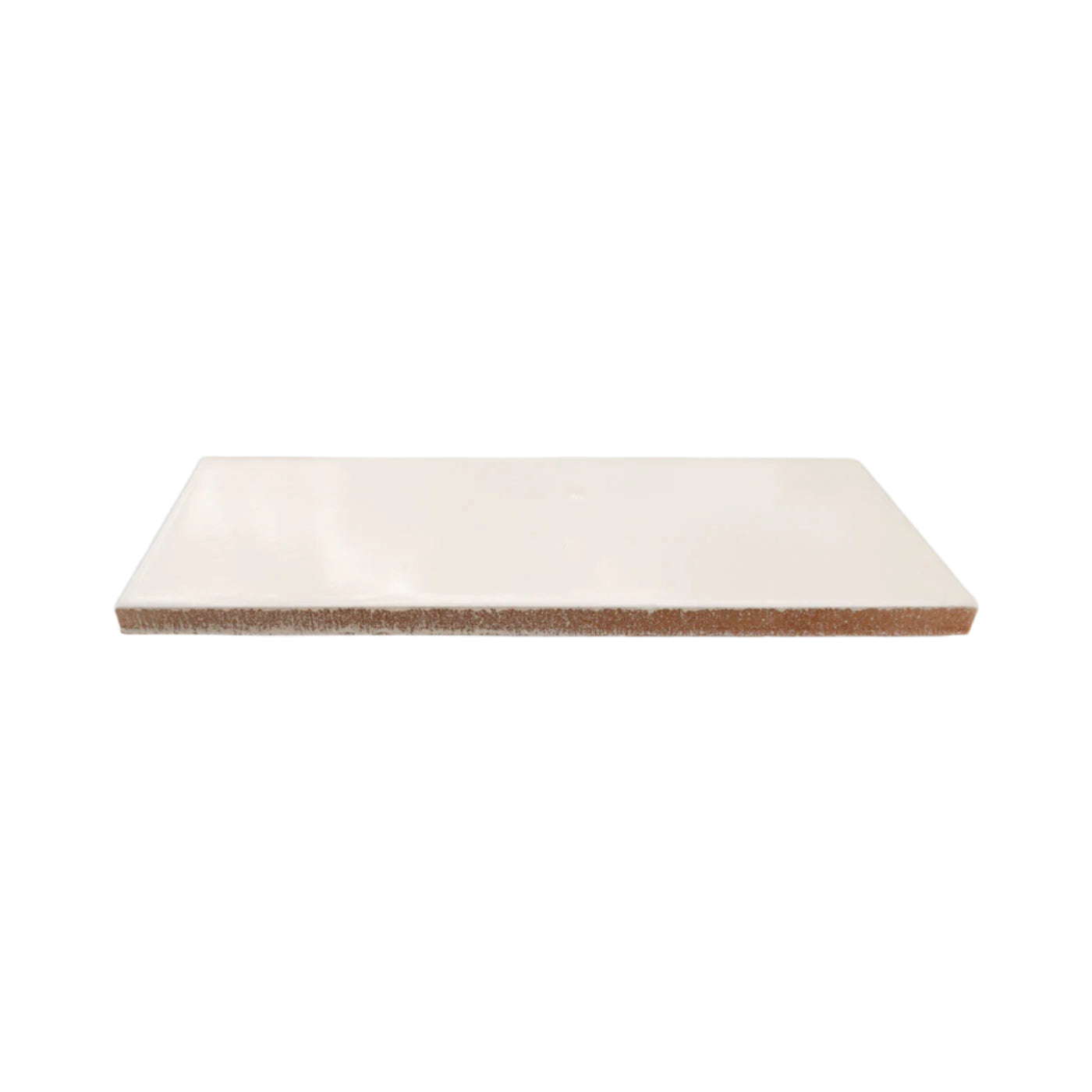 Leche creamy white solid tile by Clay Imports, showing its glossy surface and unglazed reddish-brown edge.