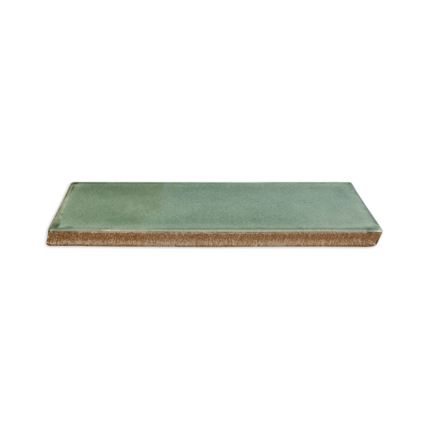 Green glazed sample tile by Clay Imports with an unglazed terracotta edge, shown angled.