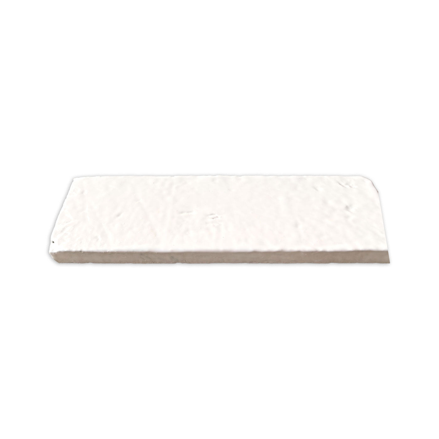 White 2.5x8 Glazed Thin Brick by Clay Imports, with a textured surface seen from an elevated angle.
