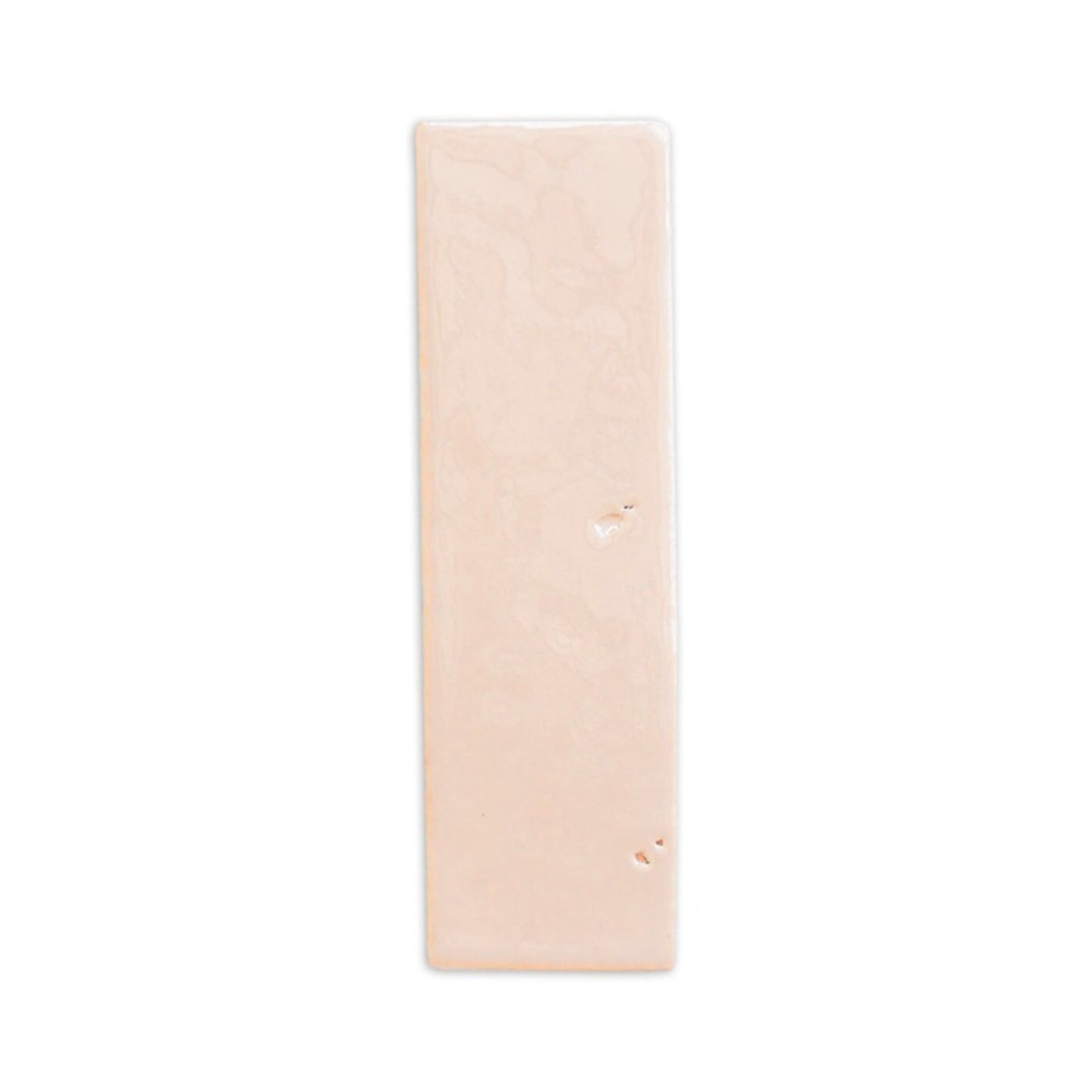 Apricot glazed thin brick sample by Clay Imports with a glossy finish and minor surface indentations, displayed vertically.