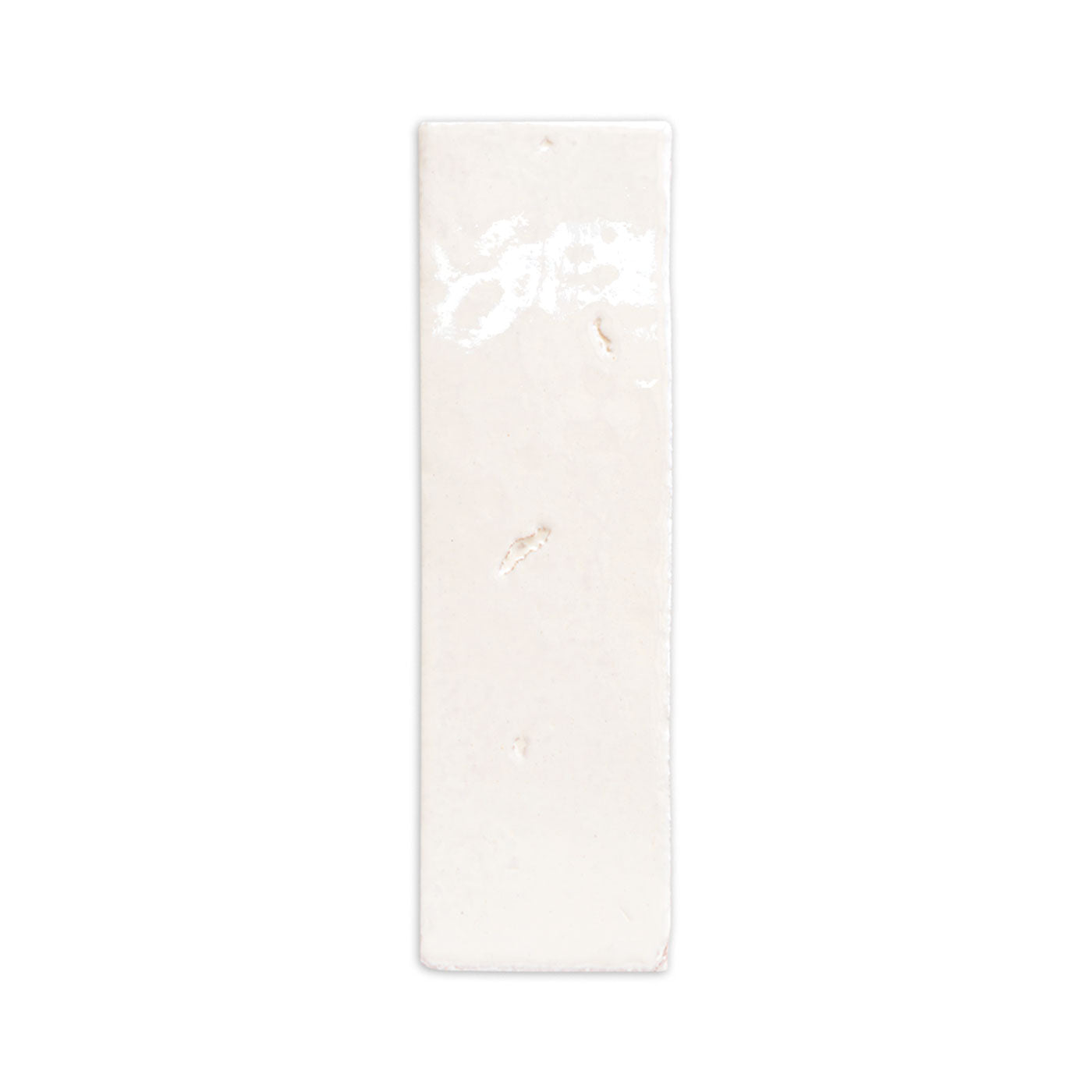 A sample of glazed thin brick by Clay Imports, in off-white with a glossy, subtly textured finish.
