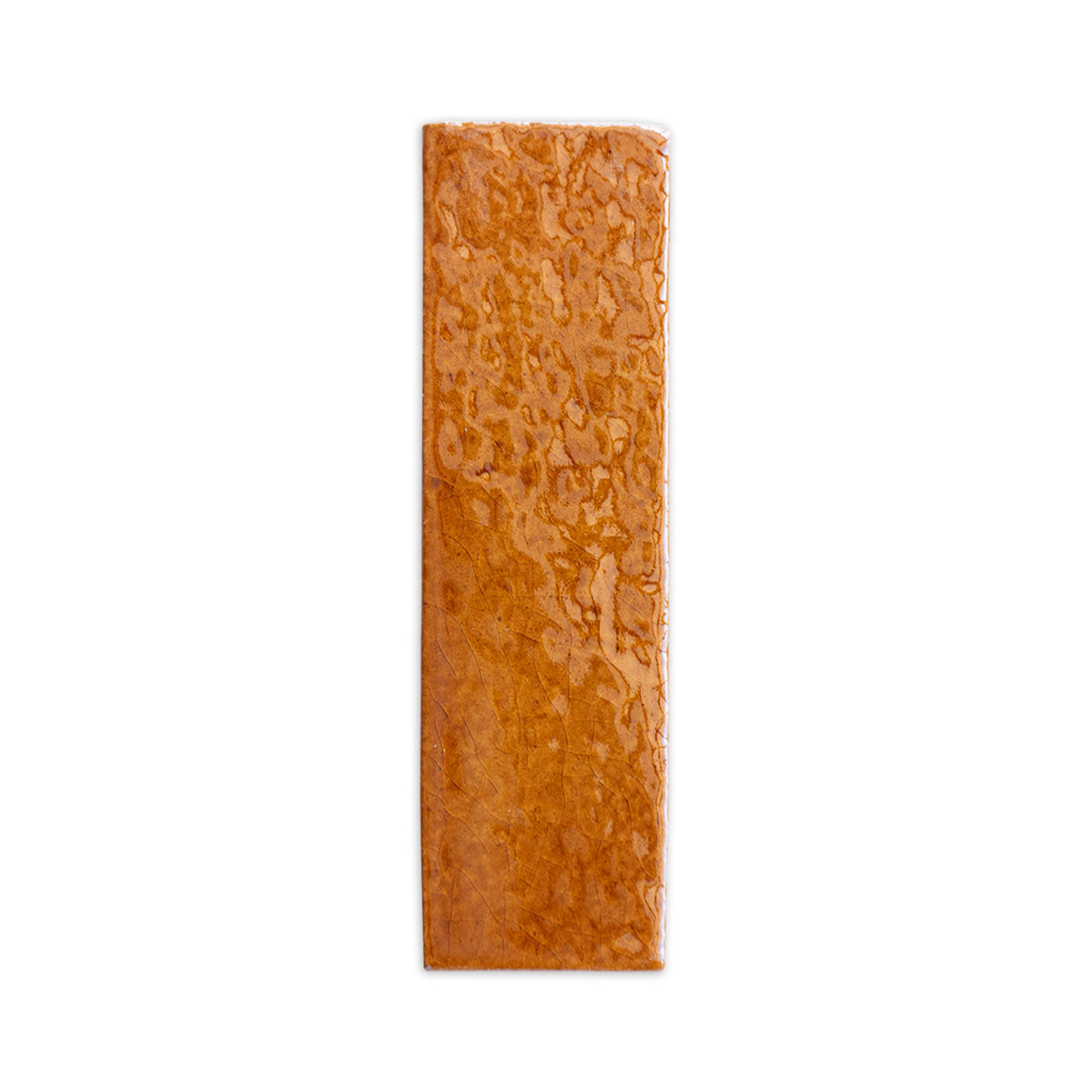 Sample of an orangey-brown glazed thin brick by Clay Imports, featuring a glossy crackle texture and natural veins.