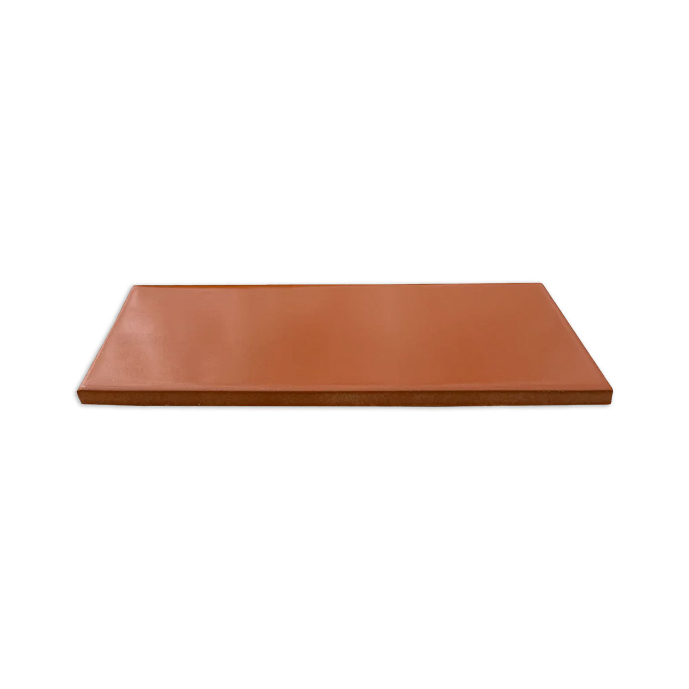 Rectangular terracotta solid tile by Clay Imports, with smooth surface and textured edges, angled view.