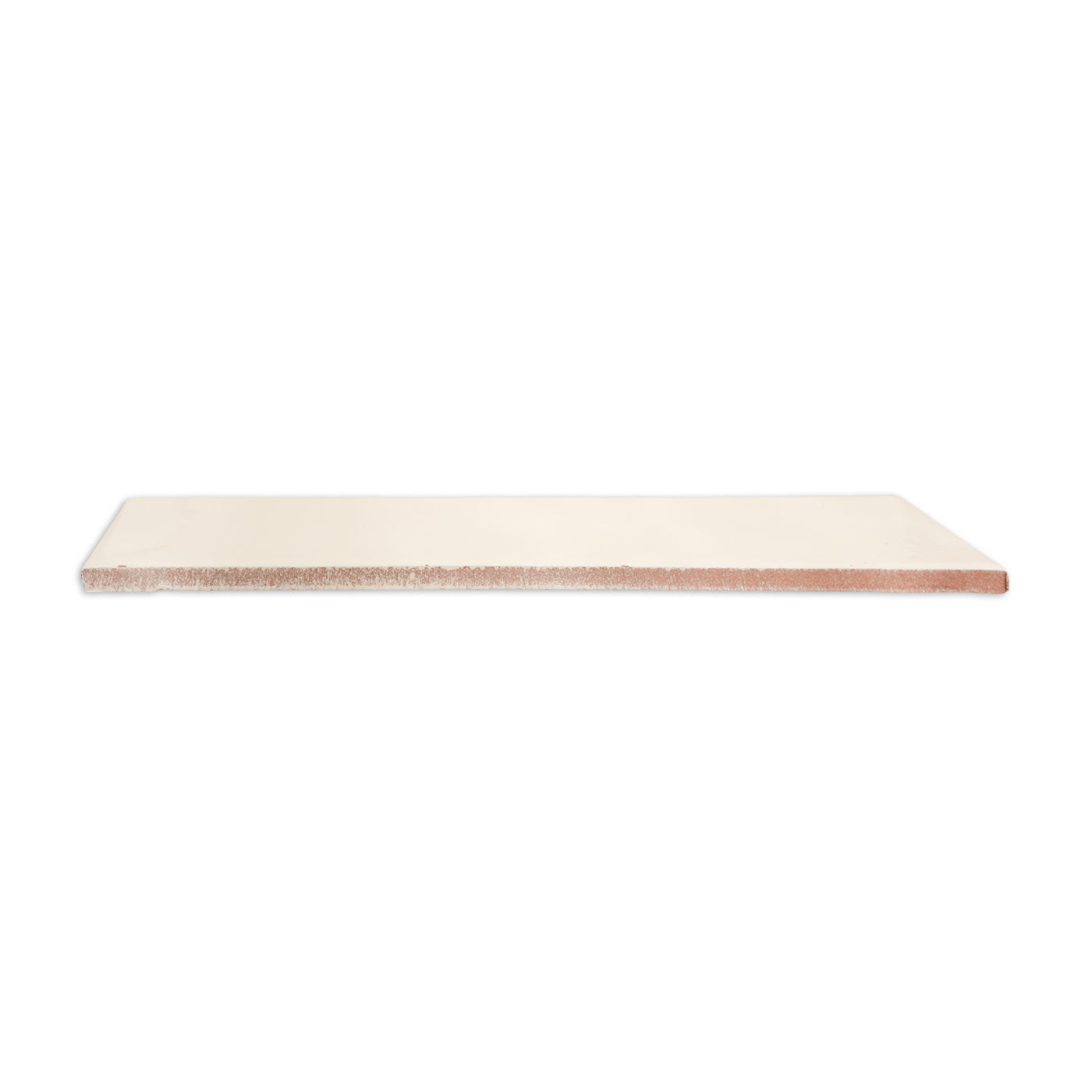 Creamy white 3x12 solid tile by Clay Imports, viewed from the side with a reddish-brown porous edge.