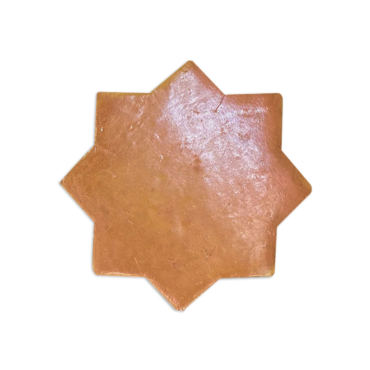 Star-shaped terracotta sample tile by Clay Imports with a rustic, slightly glossy surface.