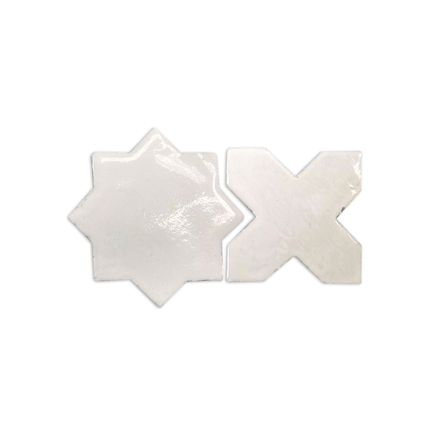 Sample of glazed smooth mini star and cross tiles by Clay Imports, in an off-white hue.