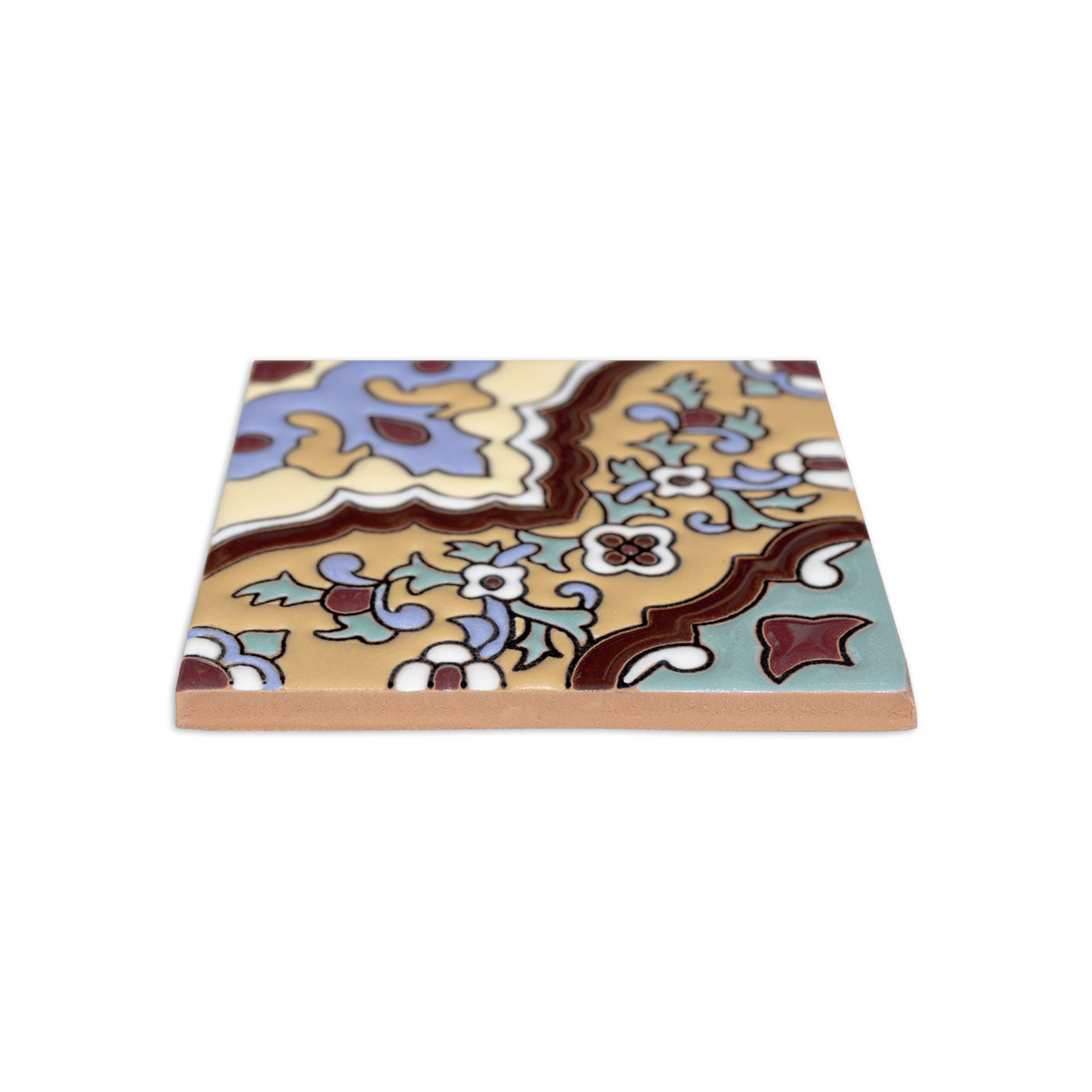 Cream and multicolor 4.25x4.25 Relief Talavera tile by Clay Imports with a raised floral and scroll pattern, side view.