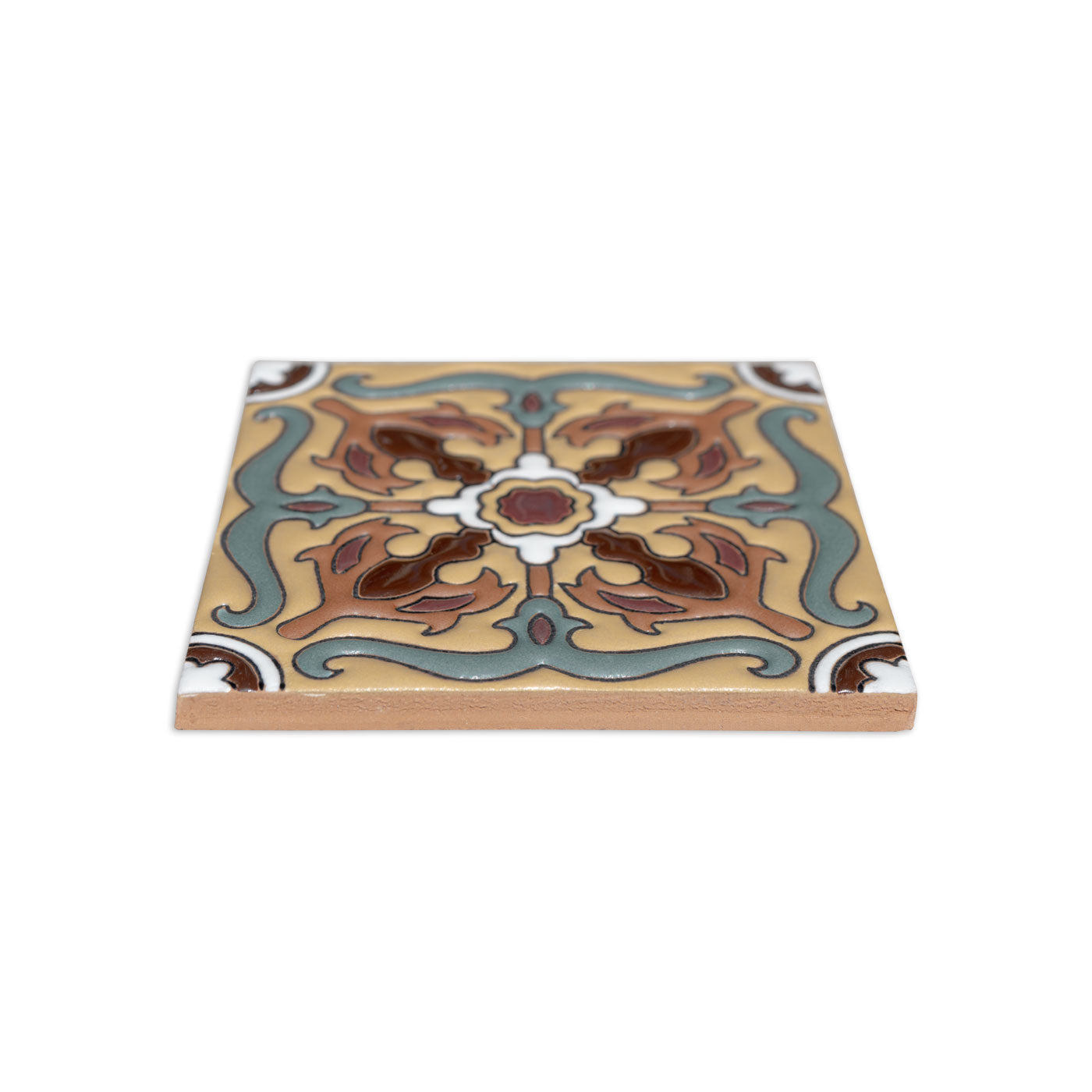 4.25x4.25 Relief Talavera tile by Clay Imports with an ornate Trancas scroll pattern in tan, teal, brown, and red glaze, seen from an angle.