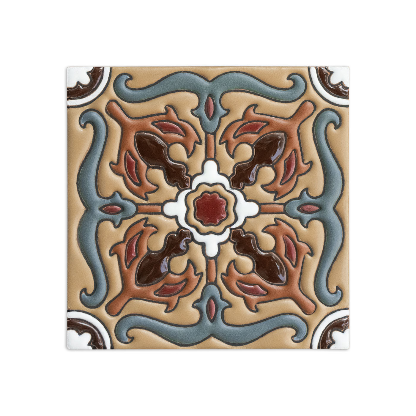 Square relief tile sample by Clay Imports, featuring an embossed symmetrical pattern in blue, brown, red, and white on a tan background.
