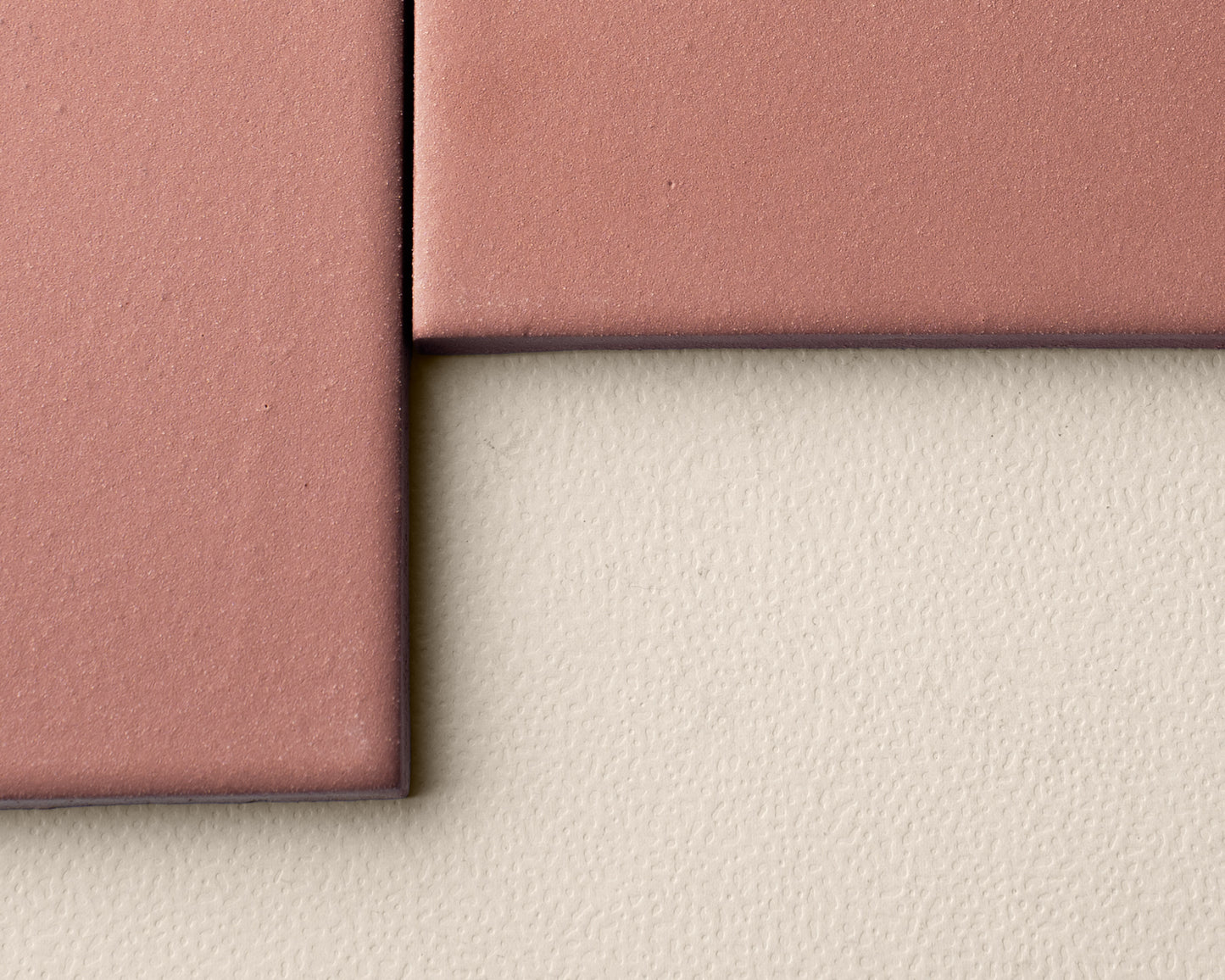 Pink clay tile by Clay Imports, with a matte textured surface and dark edges, arranged on a light background.