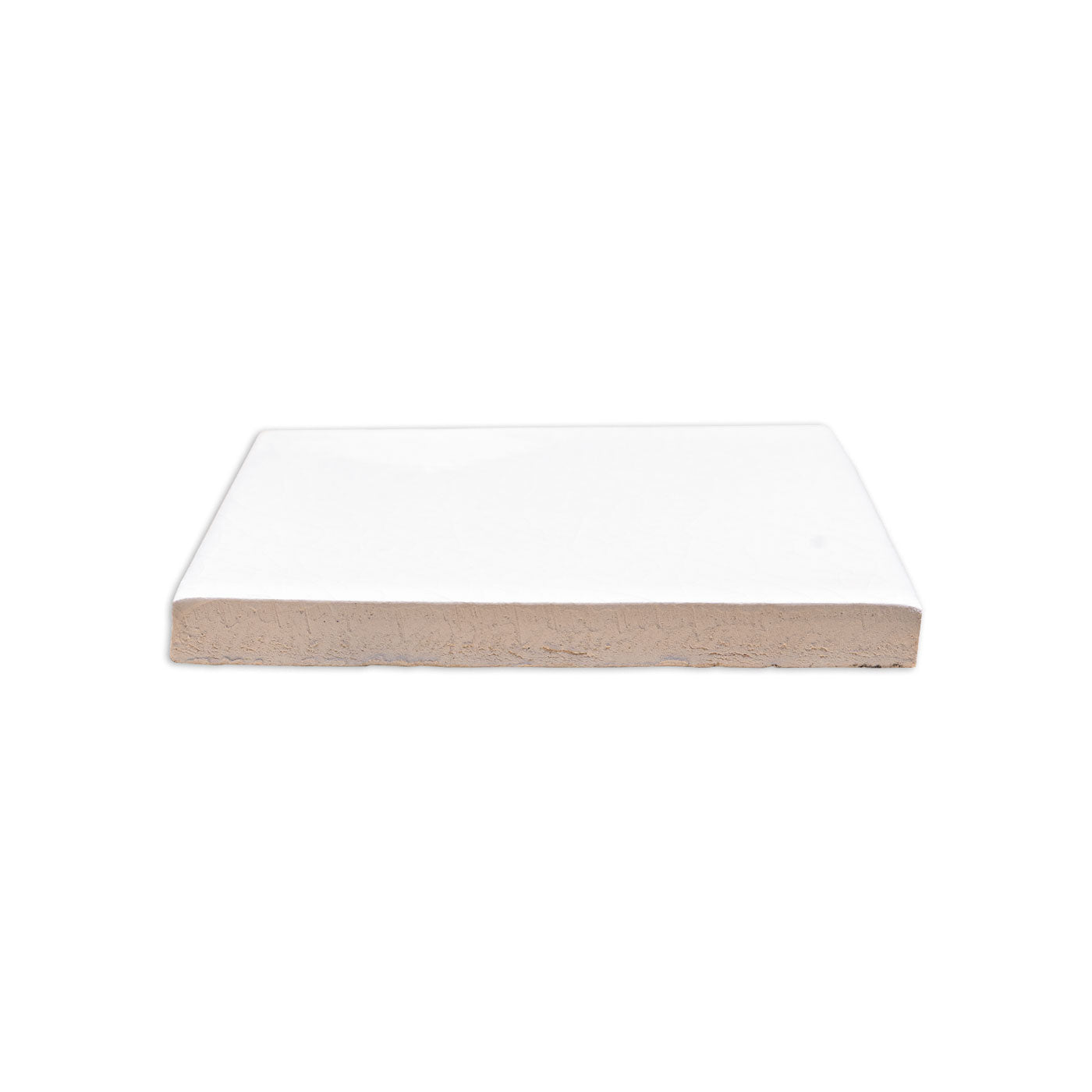 White gloss solid tile by Clay Imports, showing a light brown, unglazed, textured bottom edge in a side view.
