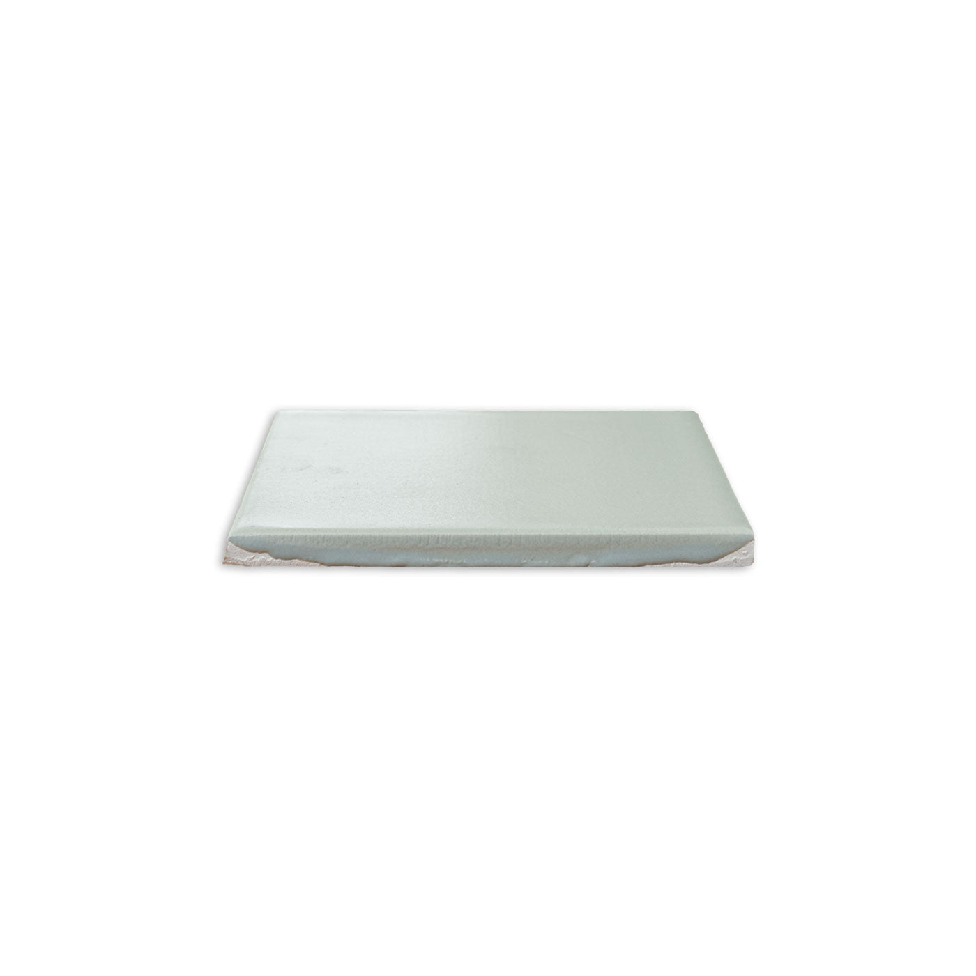 Light green Espadin Matte Solid Tile by Clay Imports, shown at an angle revealing its textured edge.