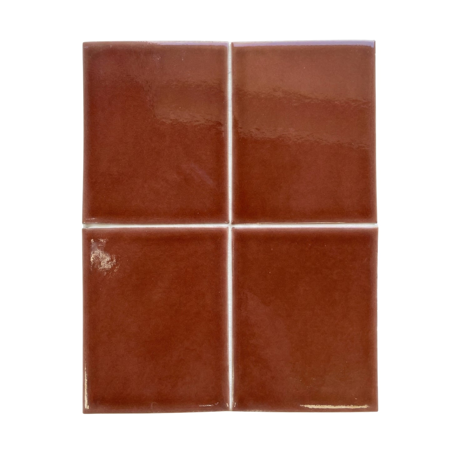 Four glossy reddish-brown solid tiles by Clay Imports, arranged in a 2x2 grid with white grout.