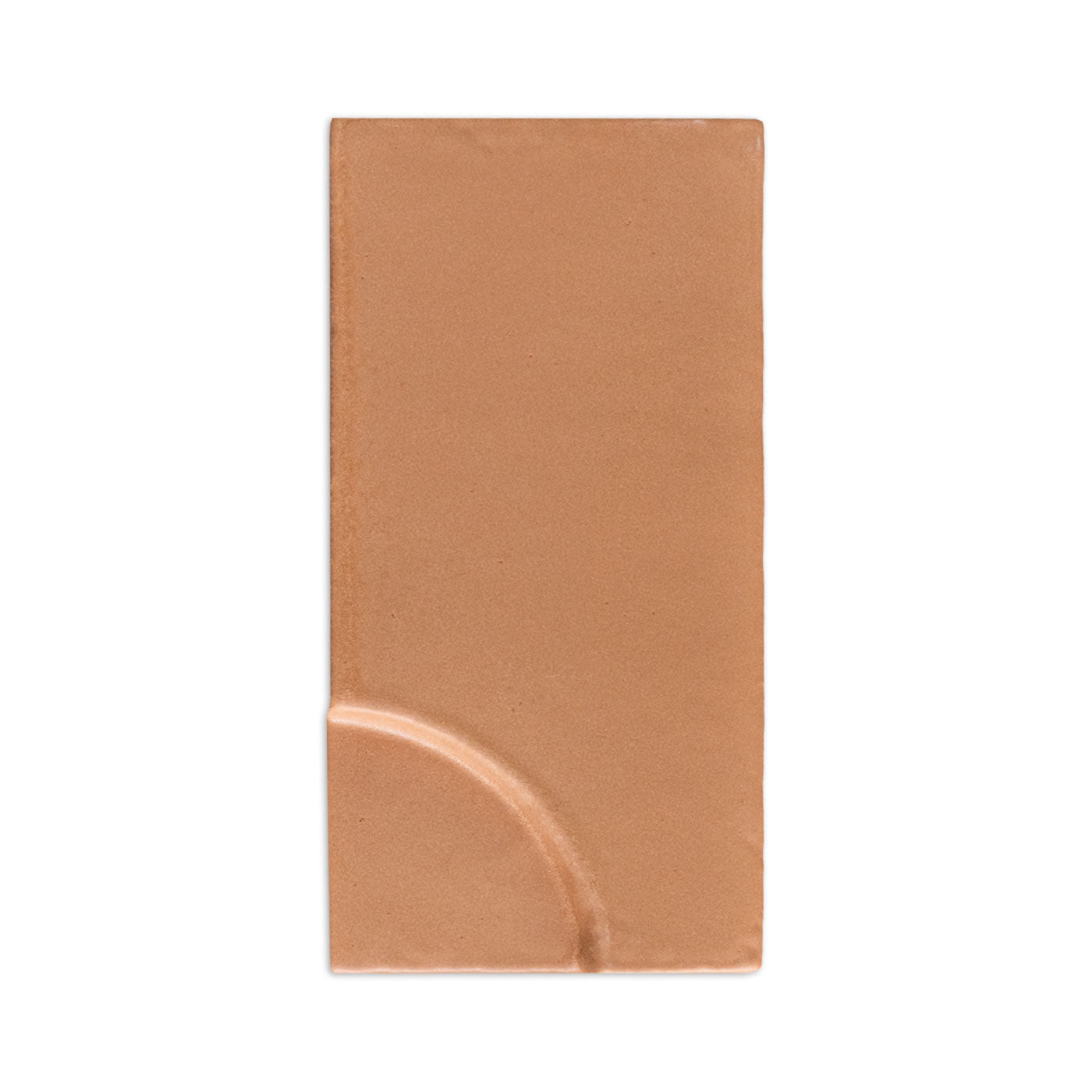 Terracotta sample tile by Clay Imports with a raised quarter-circle design on the bottom left.