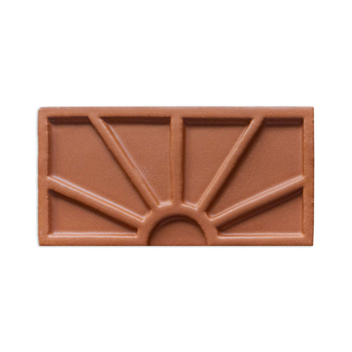 Terracotta decorative tile sample by Clay Imports with a raised sunburst pattern.