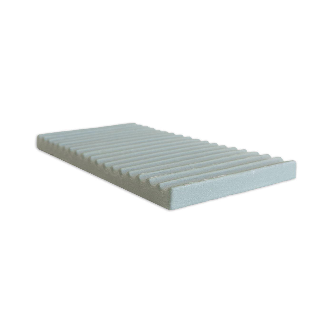 A light green rectangular shaped clay piece by Clay Imports with a ridged, corrugated surface in an angled view.