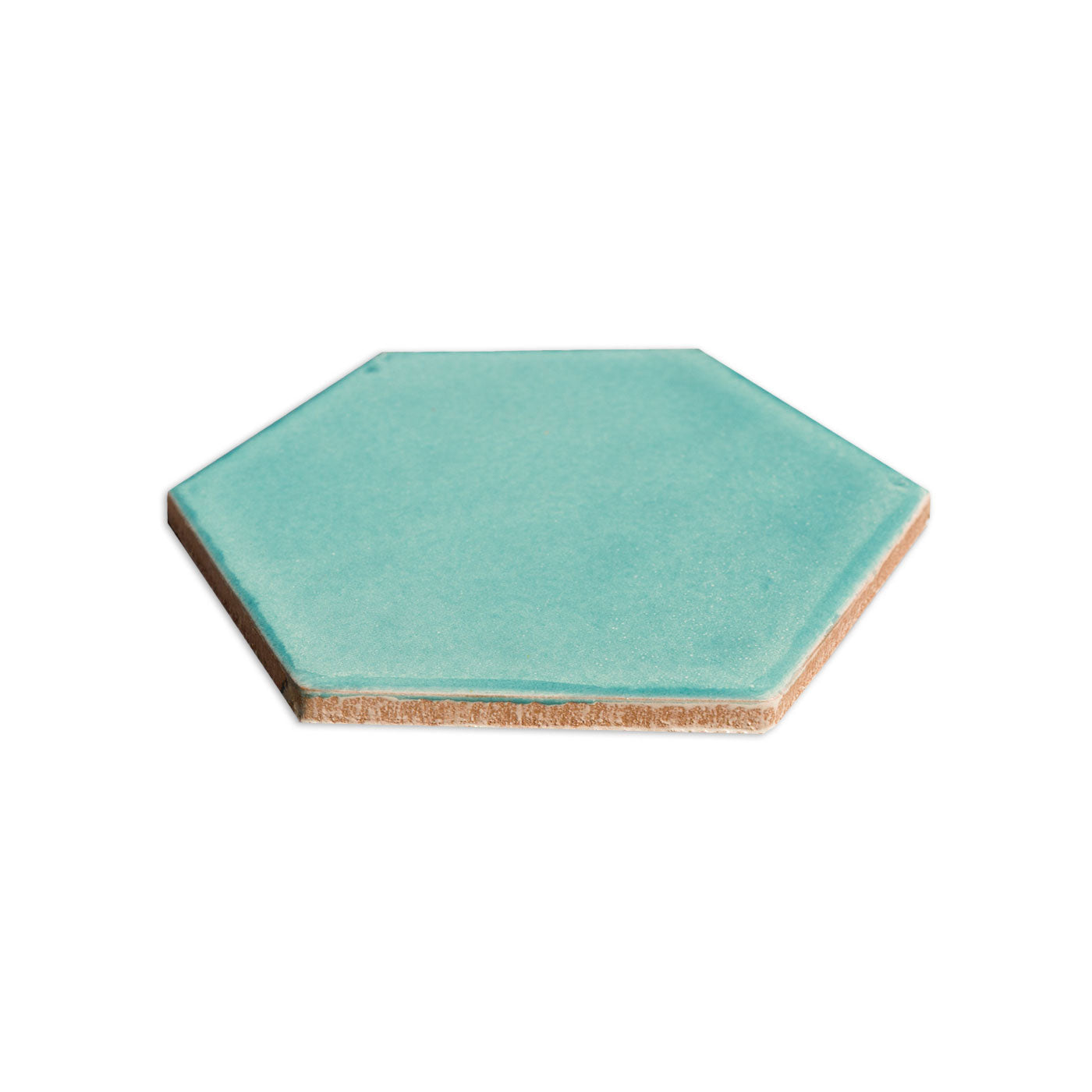 Teal Costa Hexagon tile by Clay Imports, with a glazed surface and visible unglazed clay side.