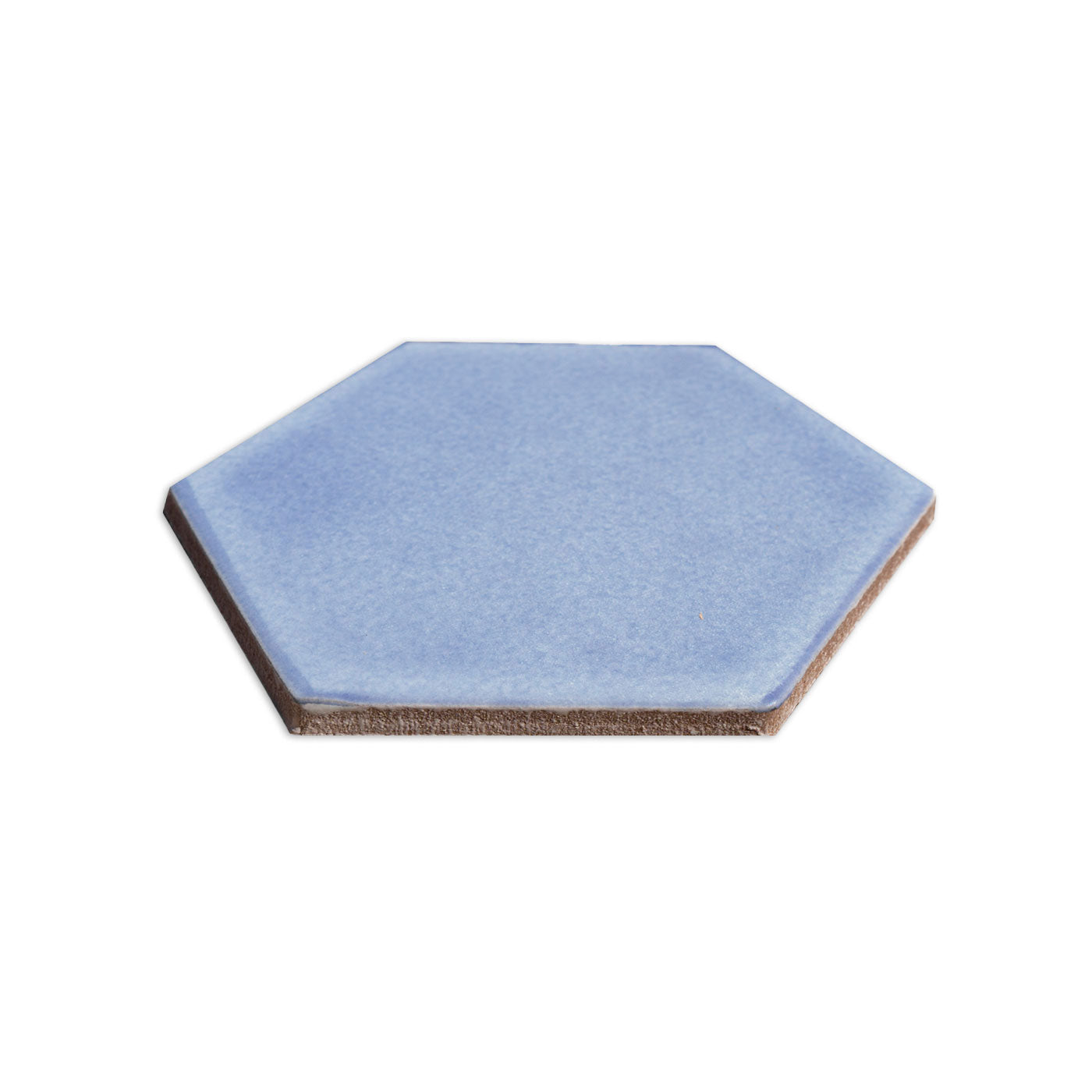 Hexagon solid tile in periwinkle blue by Clay Imports, with a matte surface and brown unglazed edges, viewed at an angle.