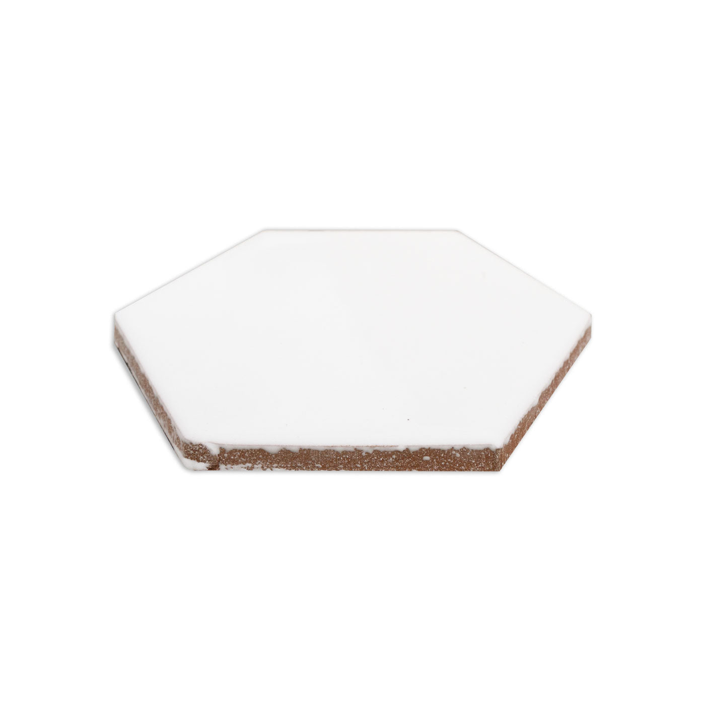 White hexagon tile by Clay Imports, showing its rough brown underside from an angled view.