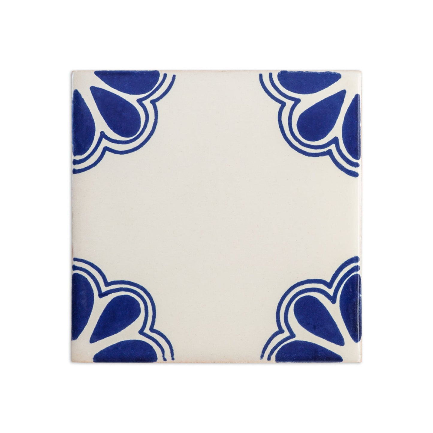 Talavera Alamos tile sample, white and blue, by Clay Imports Handmade Tile, featuring wavy blue corner patterns.