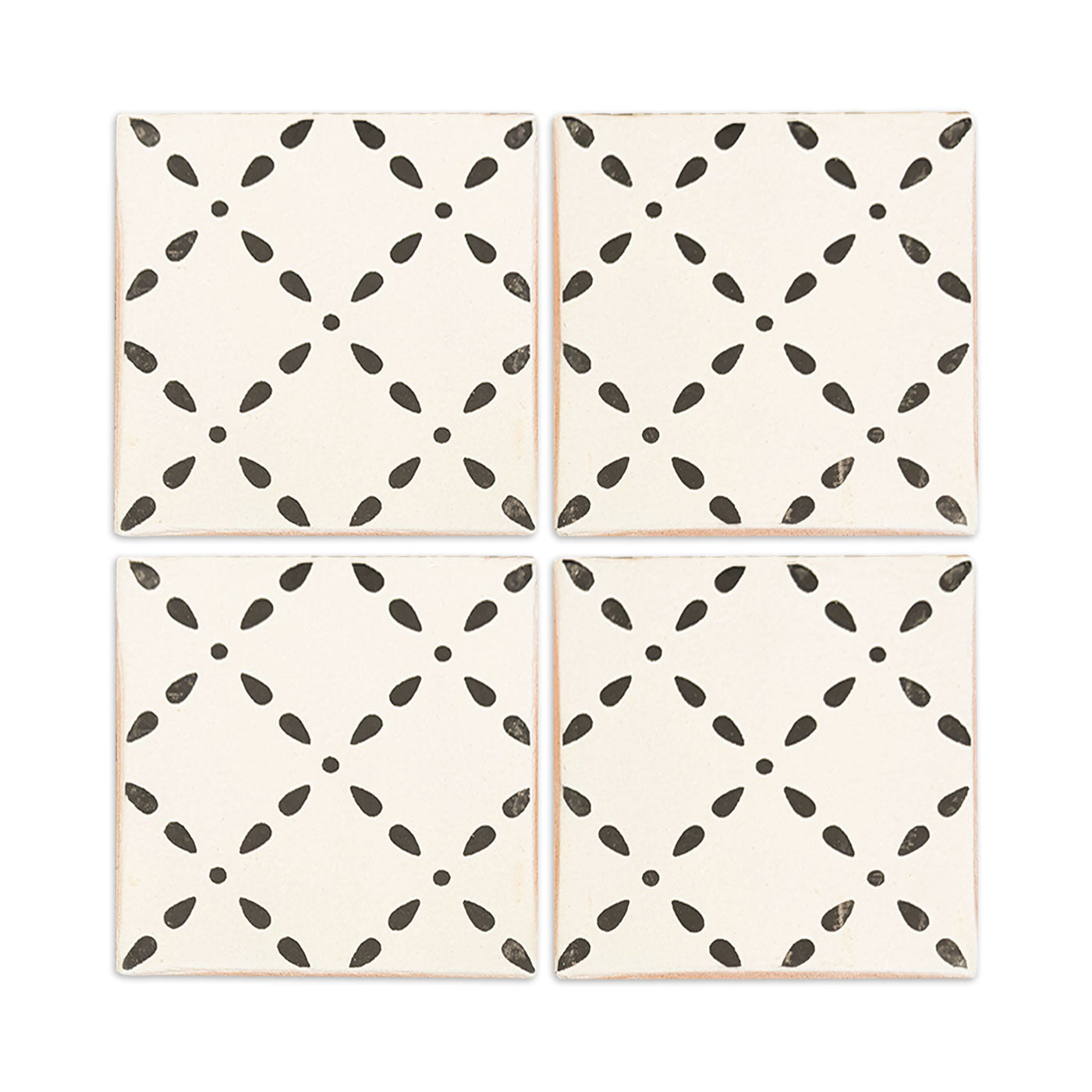 Four off-white sample tiles by Clay Imports with a repeating dark gray crossdrop pattern and distressed edges.