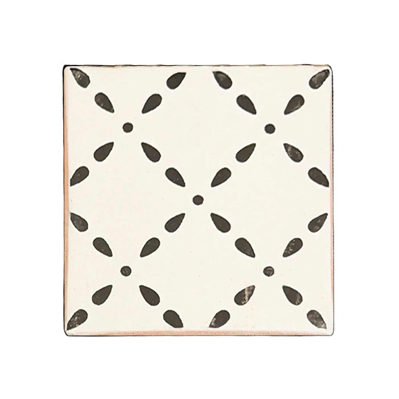 Off-white Anejo Crossdrop tile sample by Clay Imports with a repeating black petal and dot pattern.