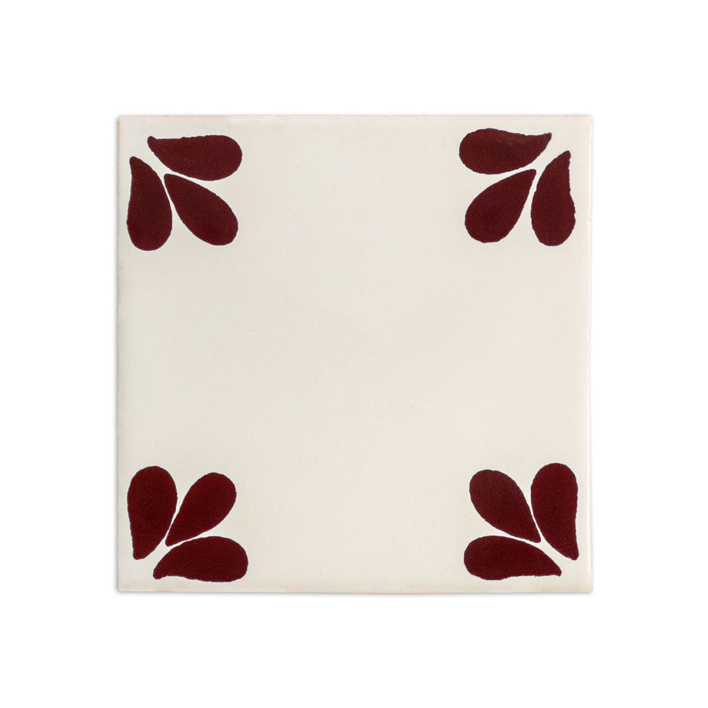 Off-white Talavera Tula tile sample by Clay Imports Handmade Tile, with oxblood teardrop shapes in each corner.