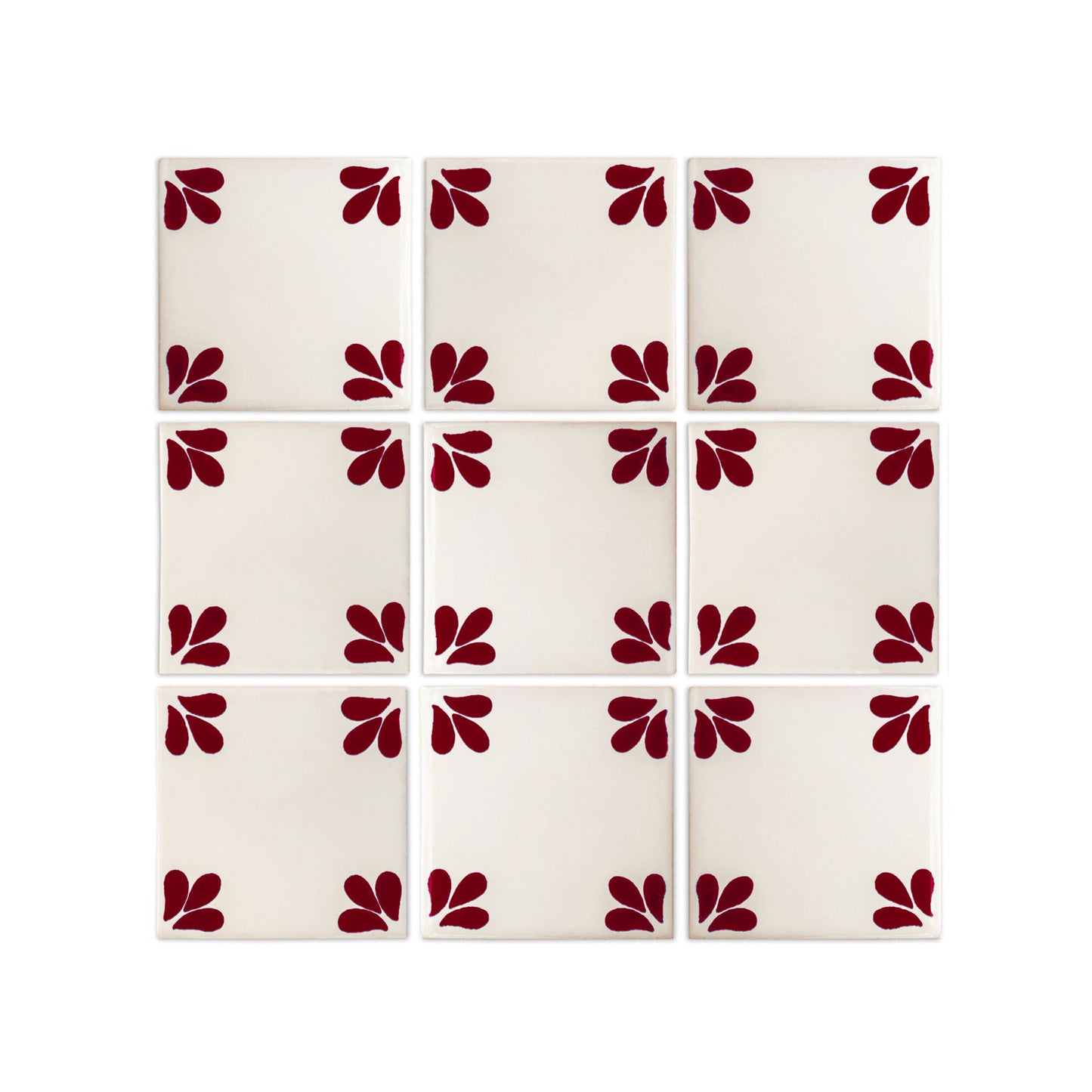 Oxblood Talavera tile by Clay Imports Handmade Tile, featuring three petal-like shapes in each corner, arranged in a 3x3 grid on an off-white background.
