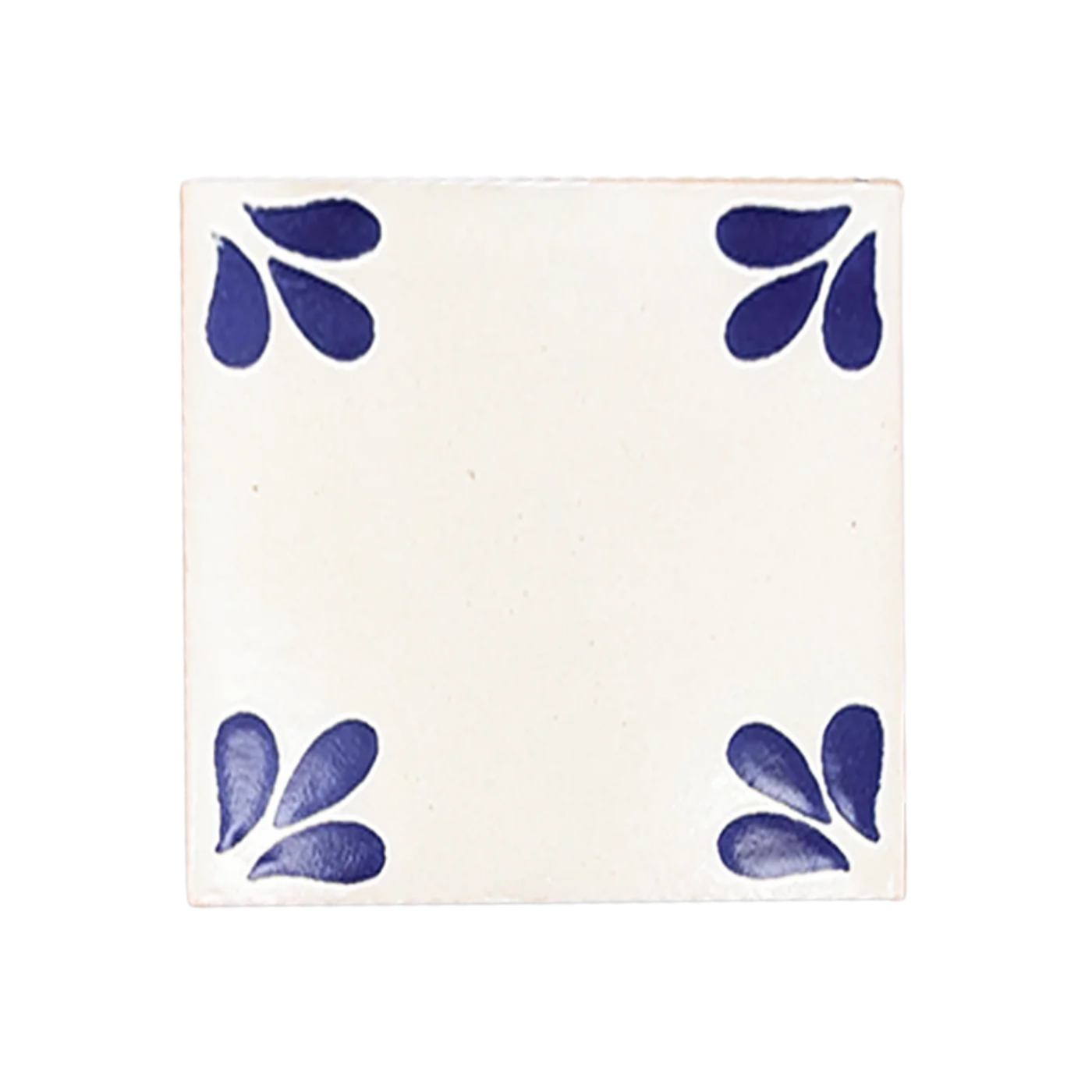 White Talavera tile sample by Clay Imports Handmade Tile with blue petal designs in each corner.