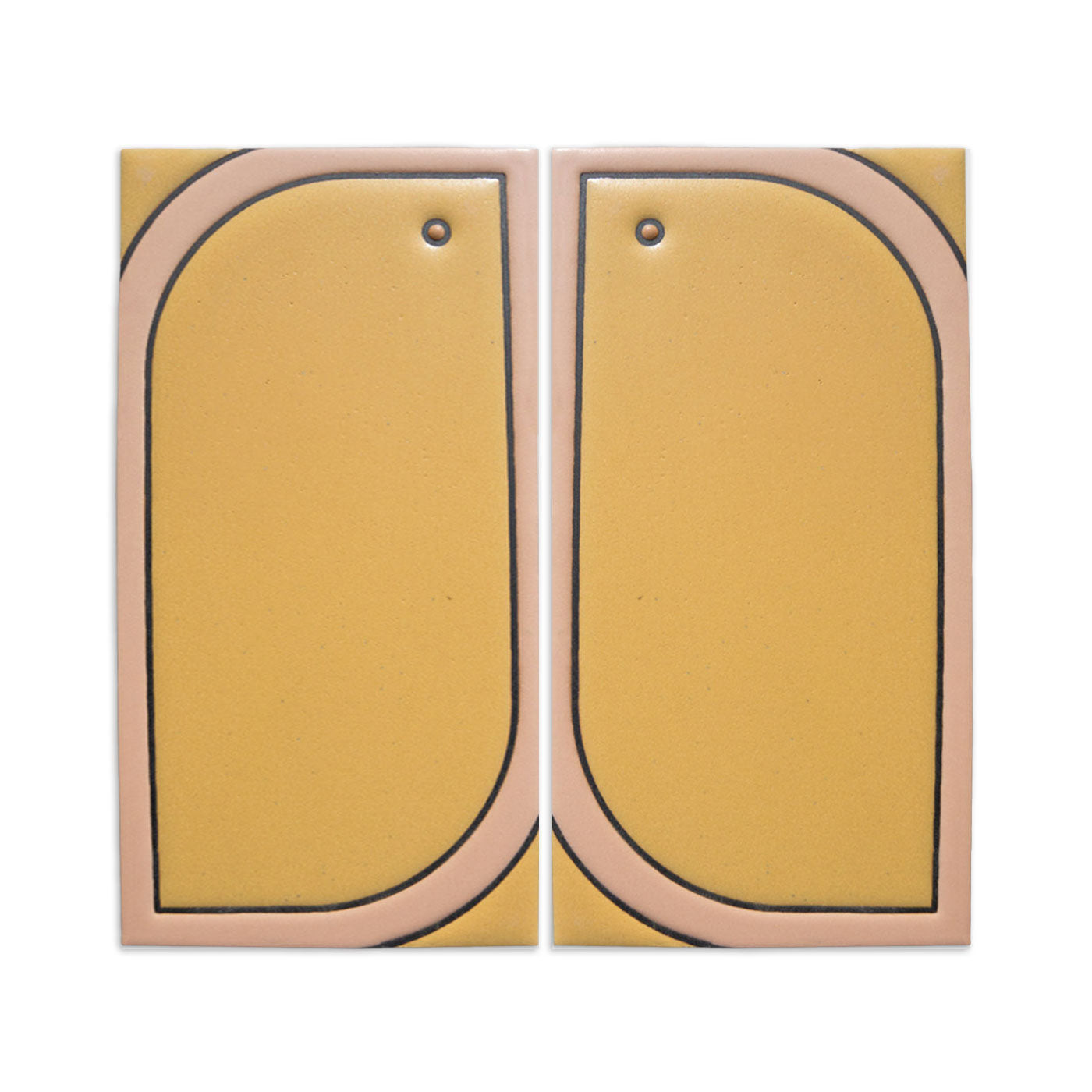 Pair of yellow and beige Pio Pio Grande tiles by Clay Imports, with black arched outlines and small top holes.