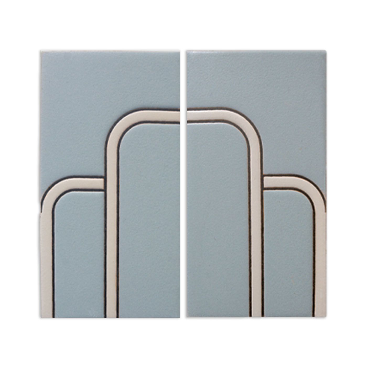 Two light blue-grey tile samples from Clay Imports with a raised off-white Art Deco geometric pattern.