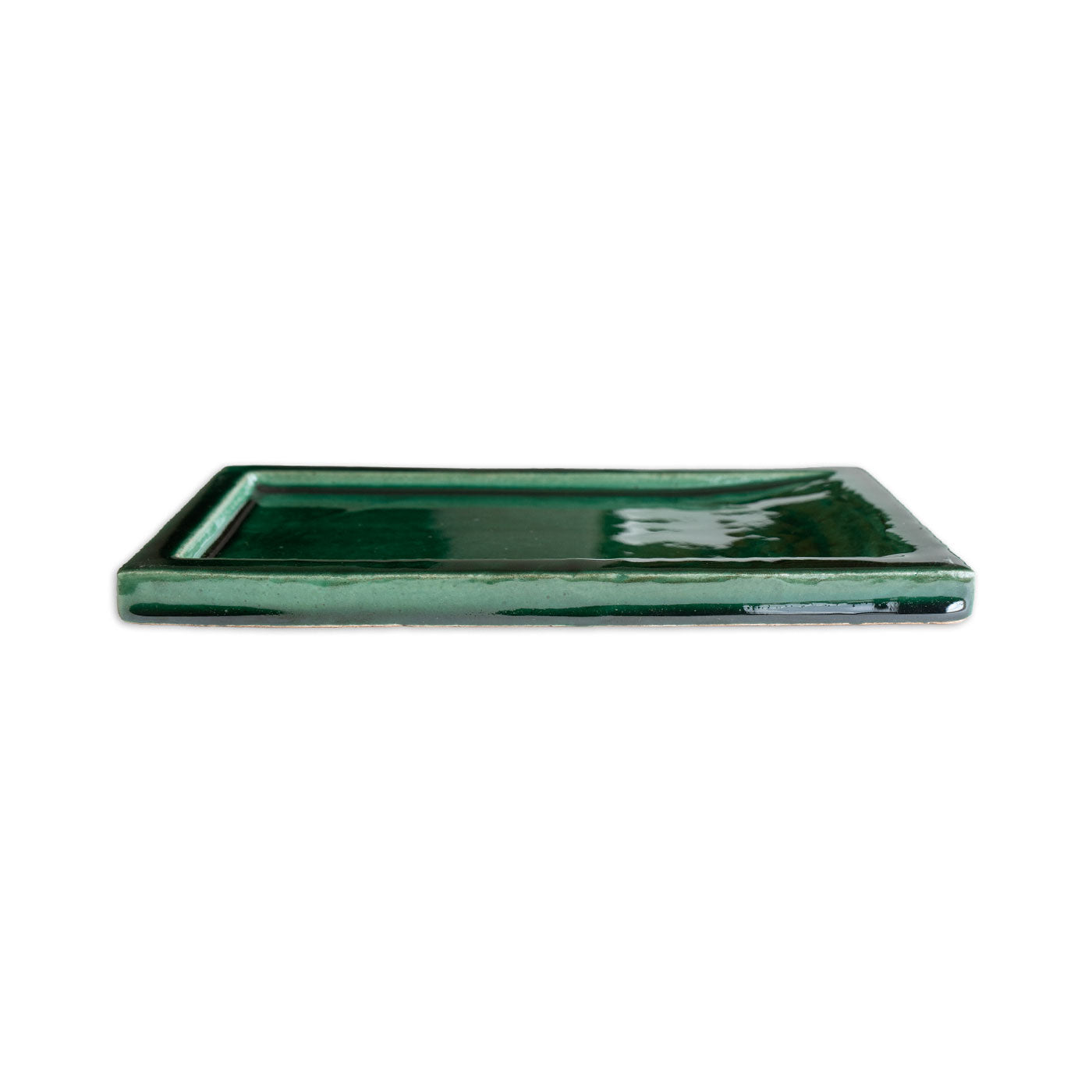 Rectangular forest green ceramic tile by Clay Imports with a glossy, textured surface, viewed from the side.