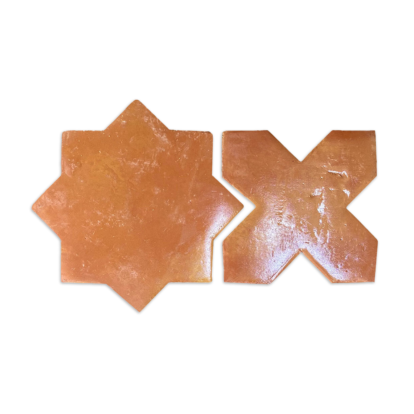 Samples of smooth gloss star and cross tiles in terracotta by Clay Imports, laid side-by-side.
