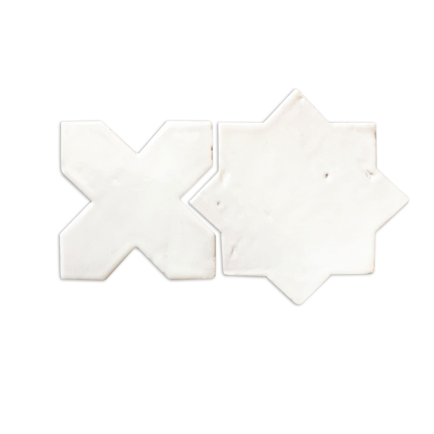 Glazed white sample tiles by Clay Imports, featuring star and cross shapes with a handcrafted finish.