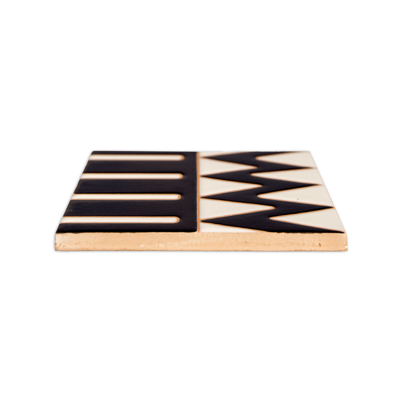 Black and white relief tile by Clay Imports featuring striped and zigzag patterns, viewed from the side.