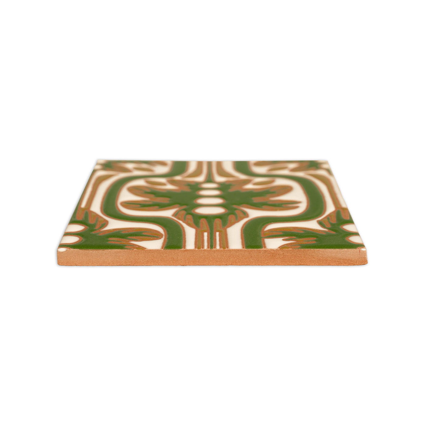 A hand-painted ceramic tile with a green and brown palmetto relief pattern by Clay Imports, shown from a low angle, revealing its natural terracotta edge.