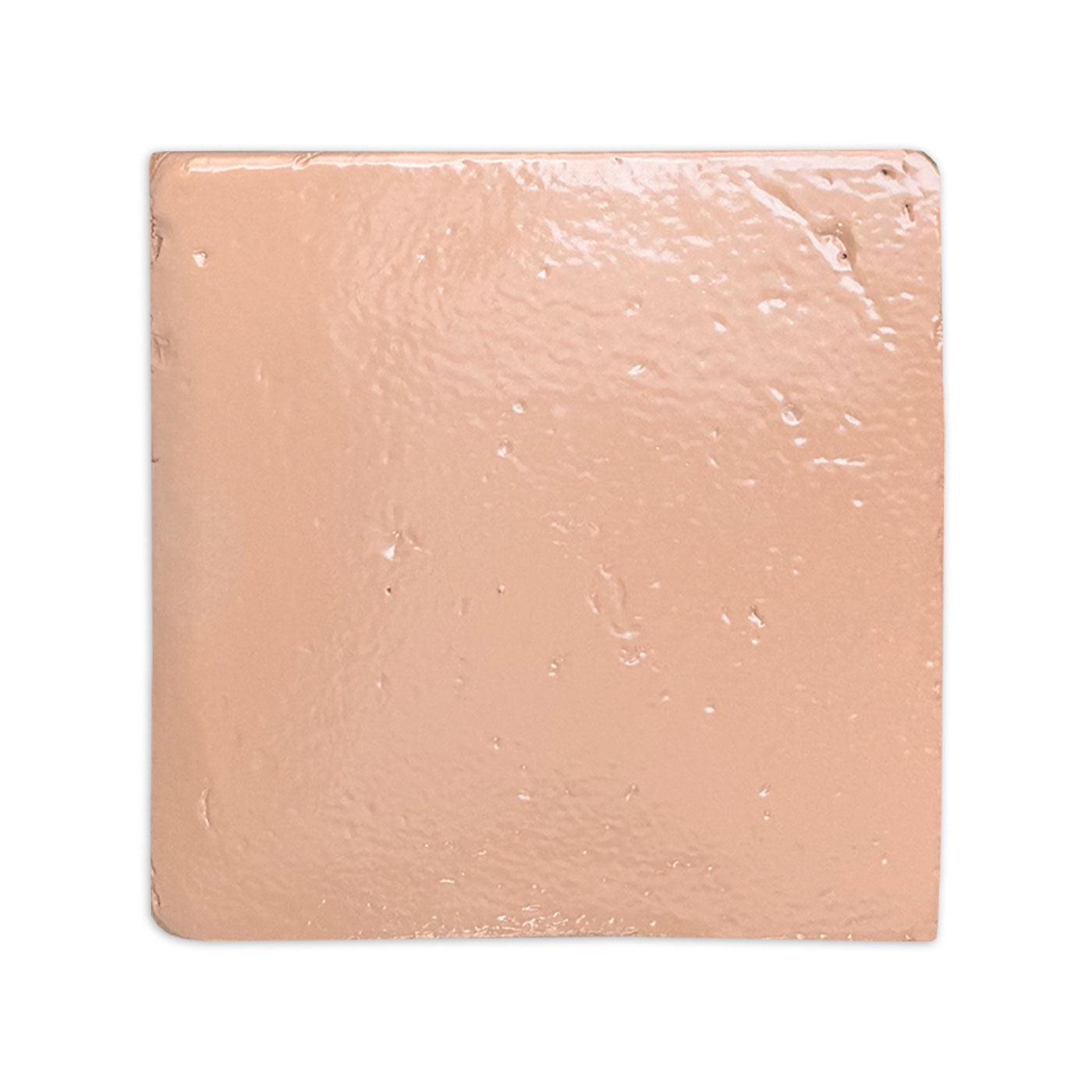 Glazed terracotta tile in a peachy-pink hue by Clay Imports, featuring a smooth, shiny, and slightly irregular surface.