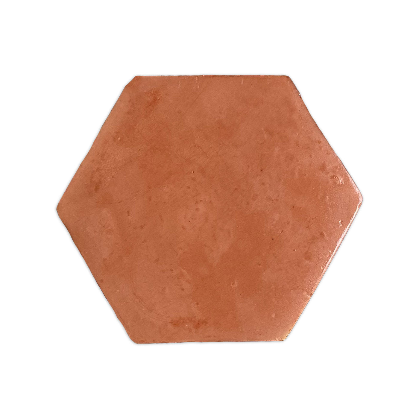 A hexagonal, reddish-brown sample tile by Clay Imports Saltillo Tile with a smooth gloss finish and slight edge irregularities.