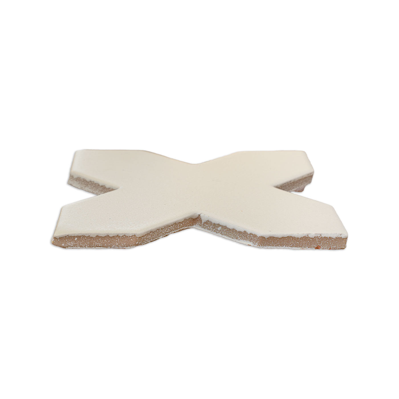 A vanilla cross solid tile by Clay Imports, viewed from an elevated angle, showing a textured surface and natural unglazed sides.