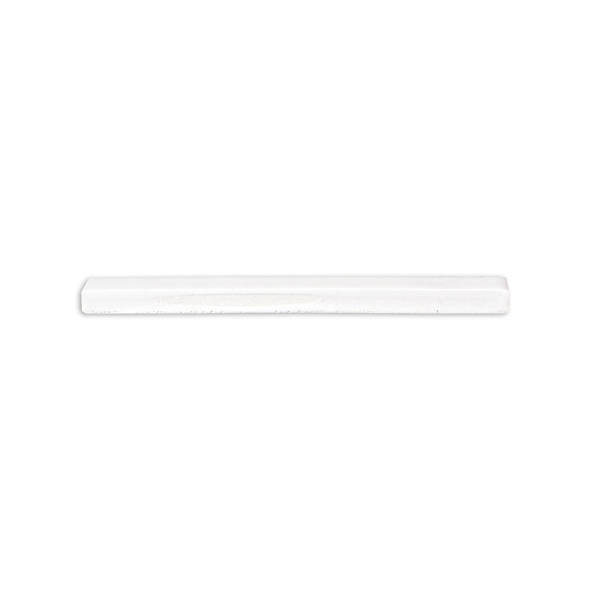 A single white glazed ceramic pencil tile lies horizontally against a plain white background.