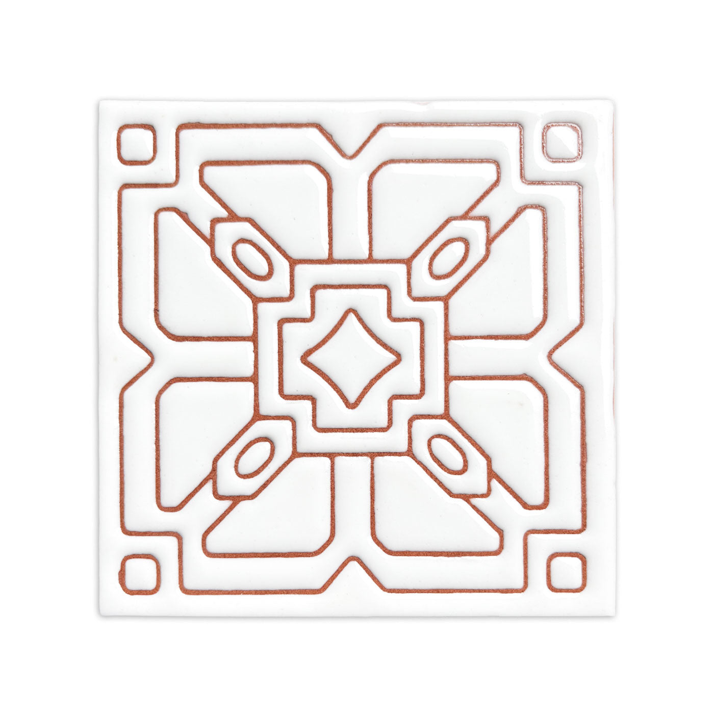 White relief Alma tile by Clay Imports with a terracotta geometric pattern.