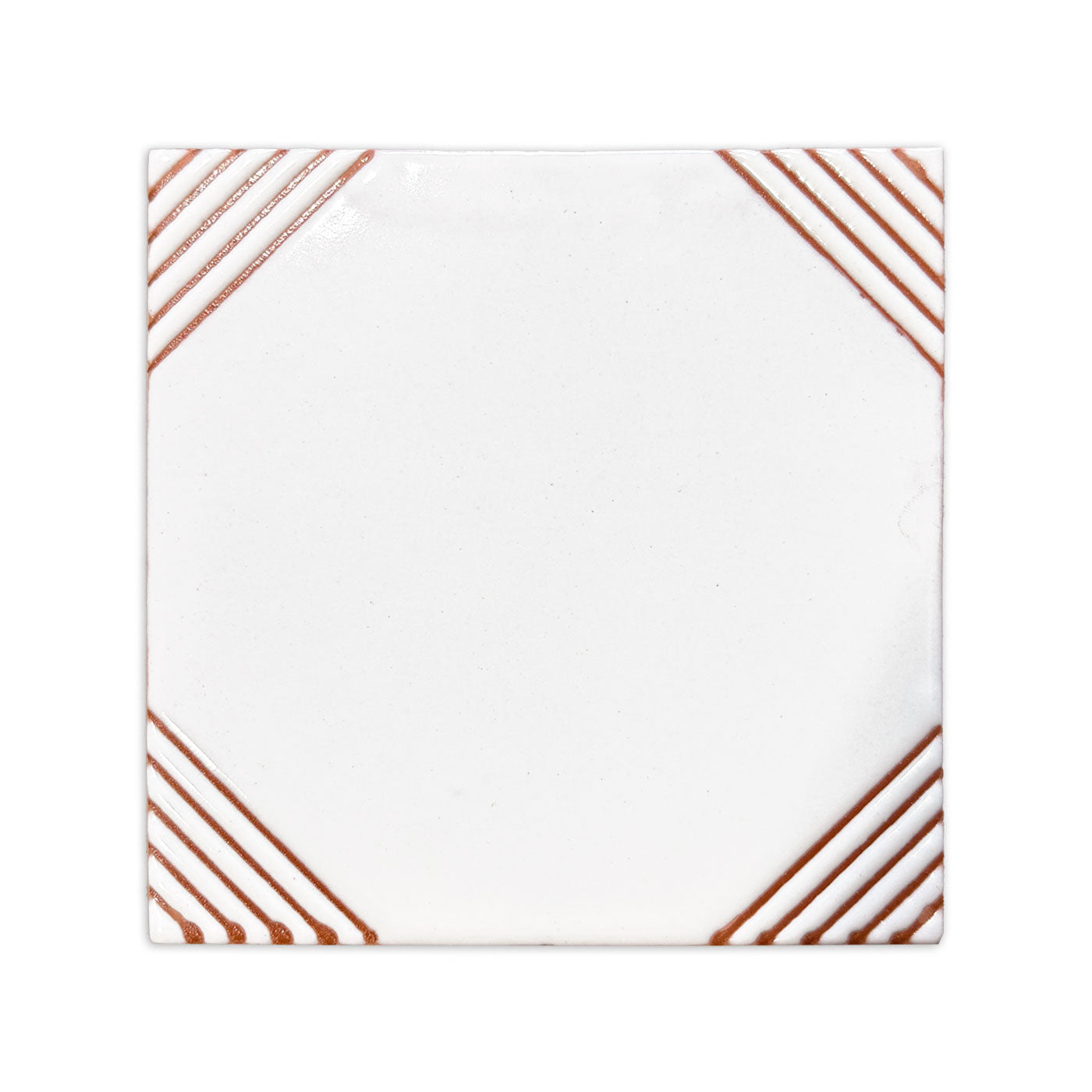 Paloma Terracotta relief tile from Clay Imports, featuring a white glaze with terracotta diagonal lines in each corner.